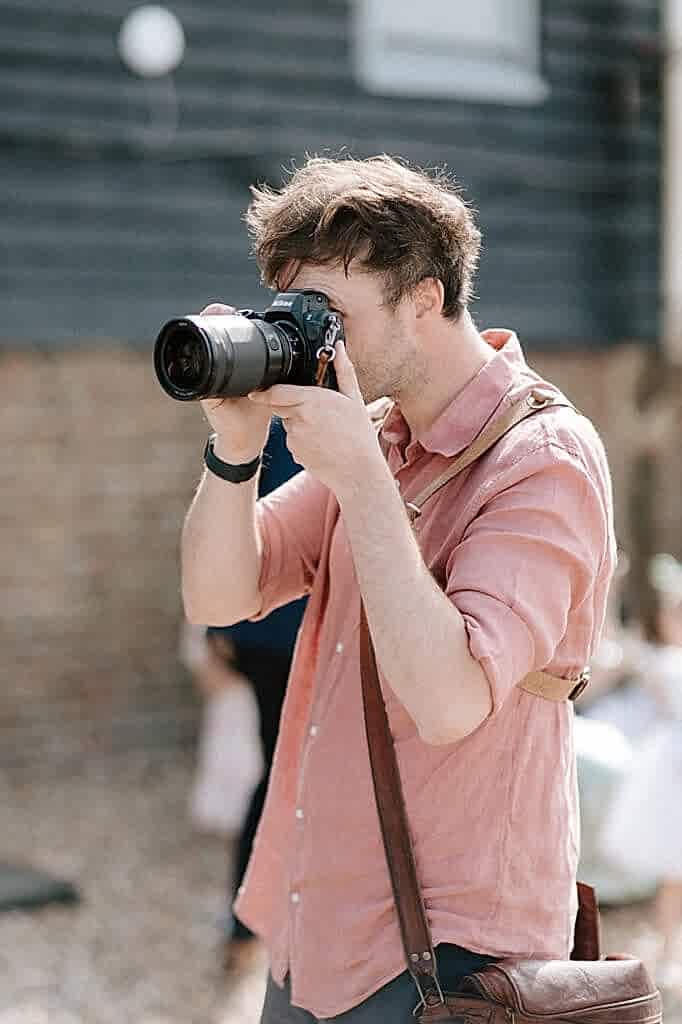 Man taking a photograph outdoors