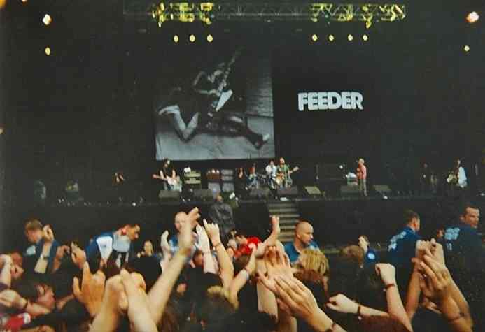 Feeder band performing live at a music festival.